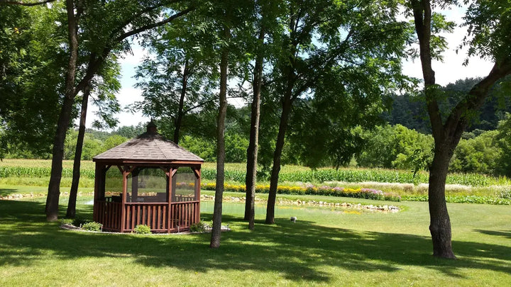 12 Foot Wood Gazebo in a Box with Screens Next to a Pond
